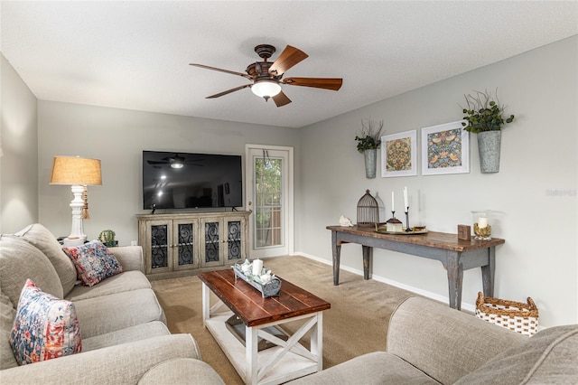 carpeted living room featuring ceiling fan and a textured ceiling