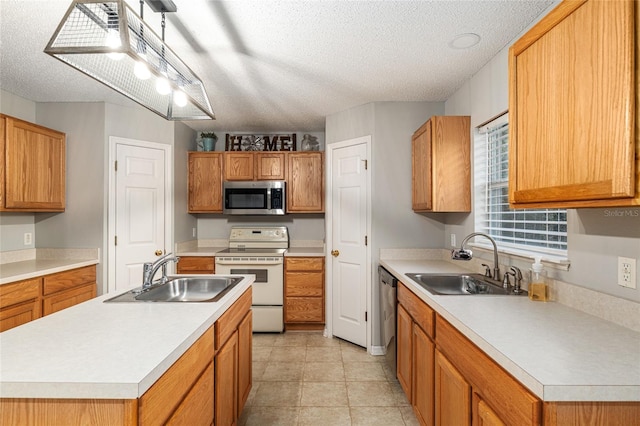 kitchen with sink, appliances with stainless steel finishes, and a textured ceiling