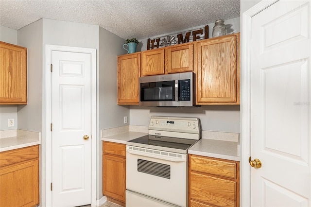 kitchen featuring range and a textured ceiling