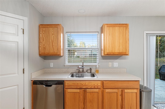 kitchen with dishwasher, a healthy amount of sunlight, a textured ceiling, and sink