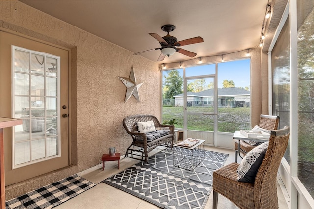 sunroom featuring ceiling fan