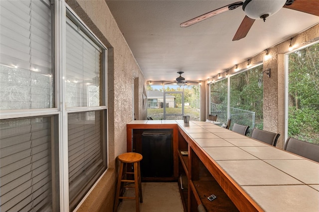 sunroom with ceiling fan