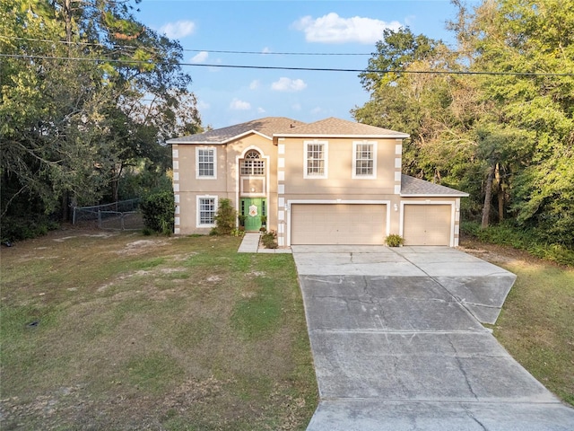 view of front of property with a front yard and a garage