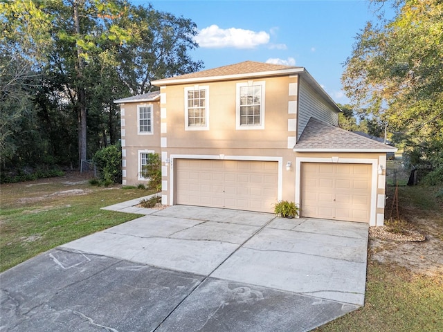 view of front of house with a front yard and a garage