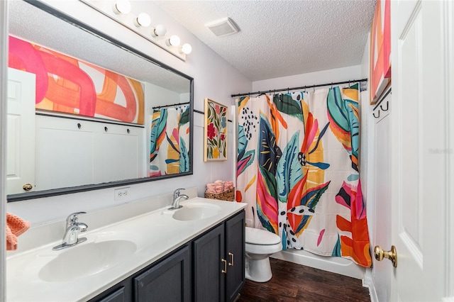 full bathroom with shower / bath combo, vanity, toilet, a textured ceiling, and wood-type flooring