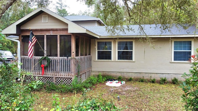 view of front of house with a sunroom and a wooden deck