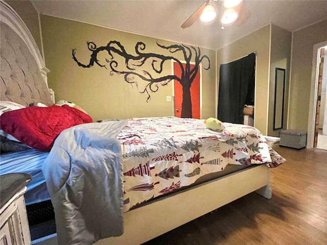 bedroom featuring hardwood / wood-style floors and ceiling fan