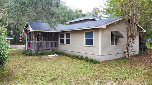 exterior space with a lawn and a sunroom