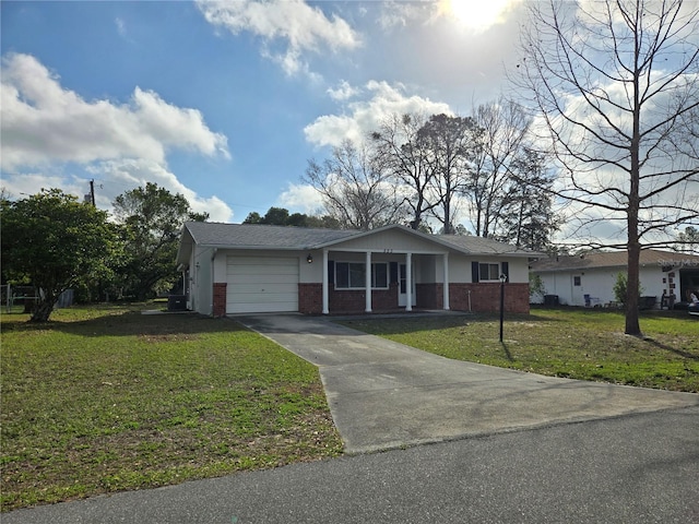 ranch-style home featuring a front lawn and a garage