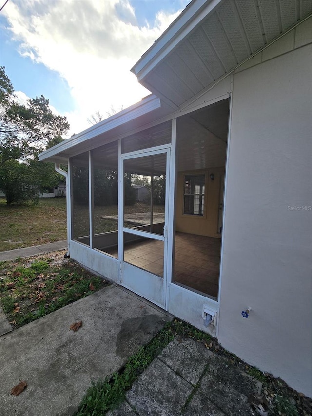 view of property exterior with a sunroom