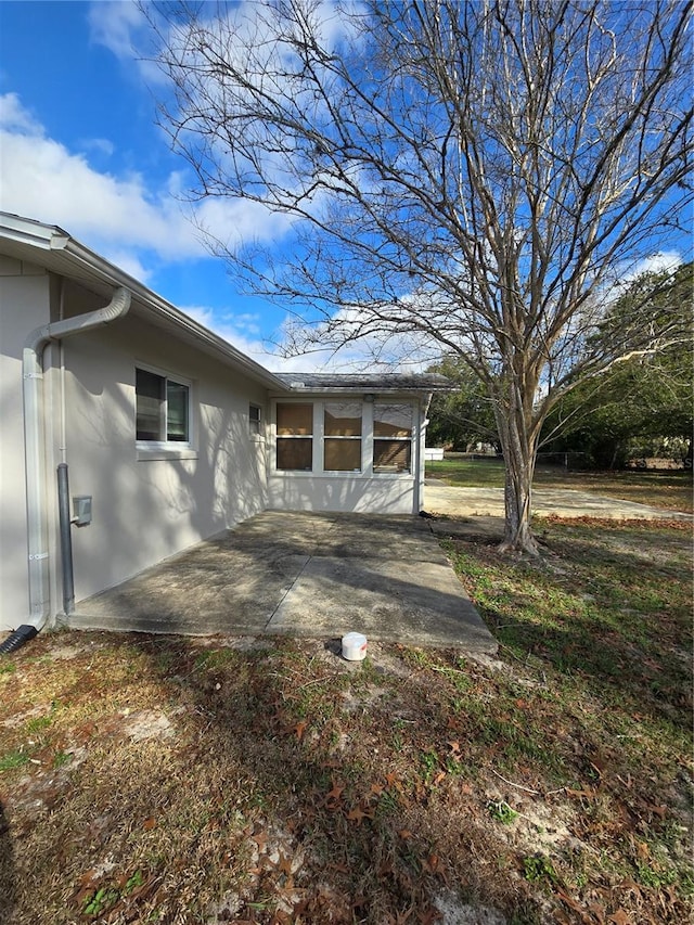 view of side of property with a patio