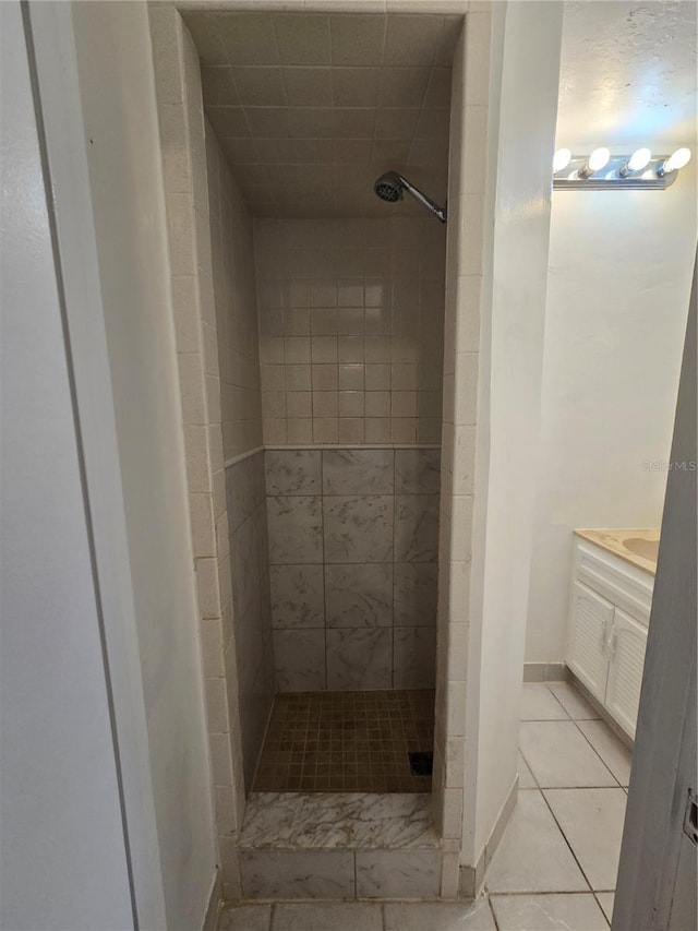 bathroom featuring vanity and tiled shower