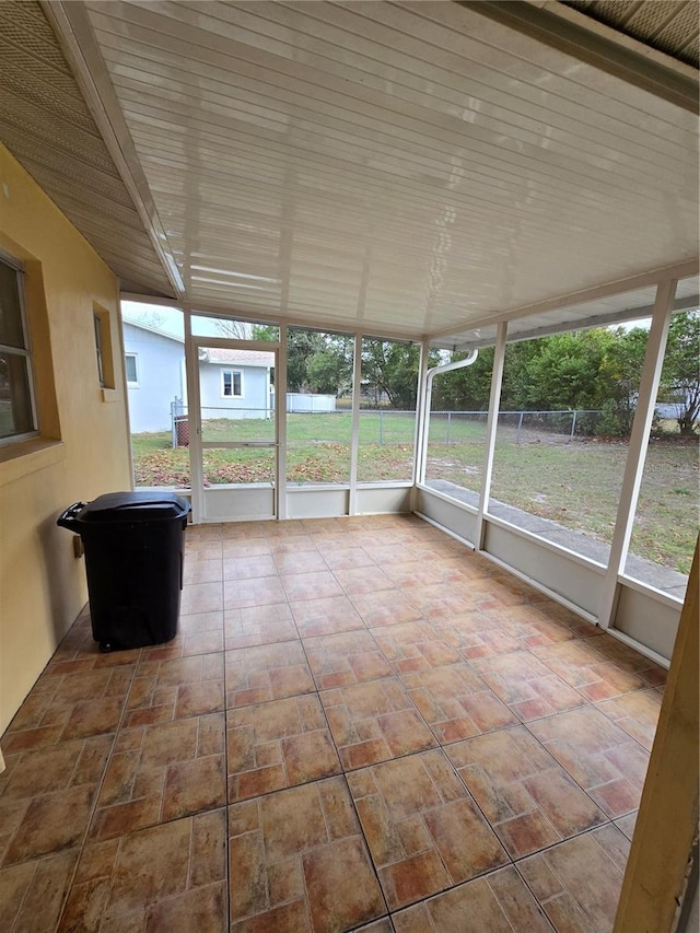 unfurnished sunroom with a healthy amount of sunlight and wood ceiling