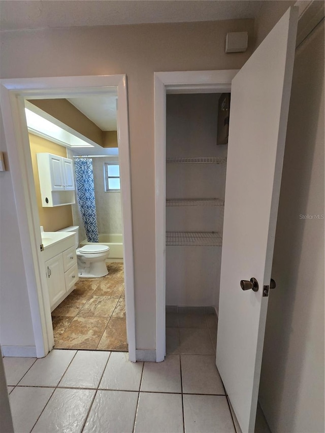 full bathroom featuring vanity, shower / bath combo, toilet, and tile patterned floors