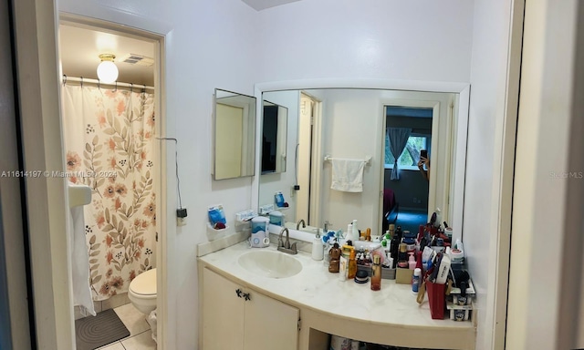 bathroom featuring walk in shower, tile patterned flooring, vanity, and toilet