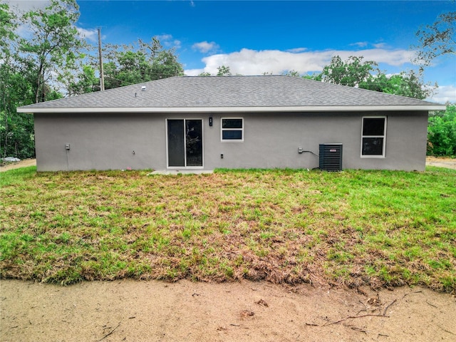 back of house featuring a lawn and central AC