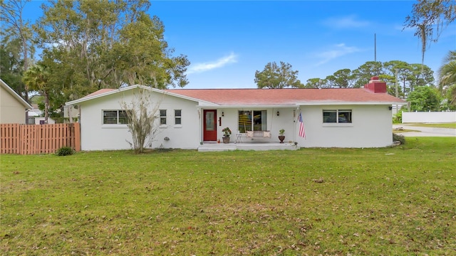 back of house featuring a yard