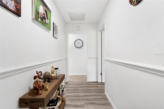 hallway with light hardwood / wood-style floors