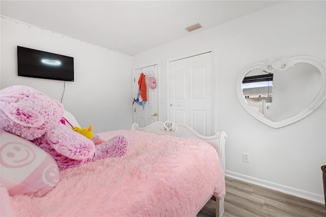 bedroom with hardwood / wood-style floors