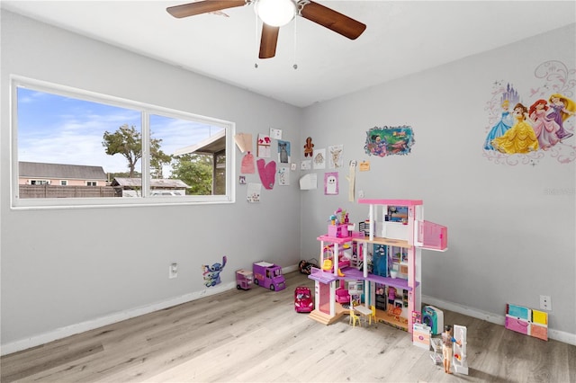 game room with ceiling fan, plenty of natural light, and light hardwood / wood-style flooring