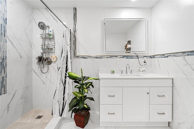 bathroom with tiled shower, tile walls, and vanity