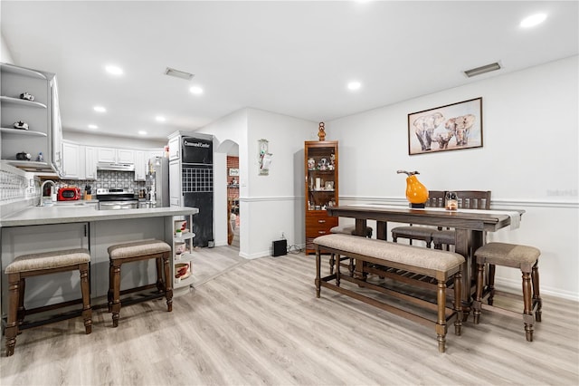 dining area with light hardwood / wood-style flooring and sink