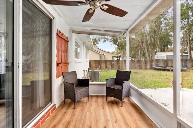 sunroom featuring ceiling fan