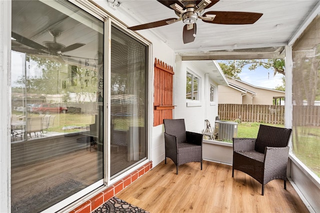 sunroom / solarium featuring ceiling fan