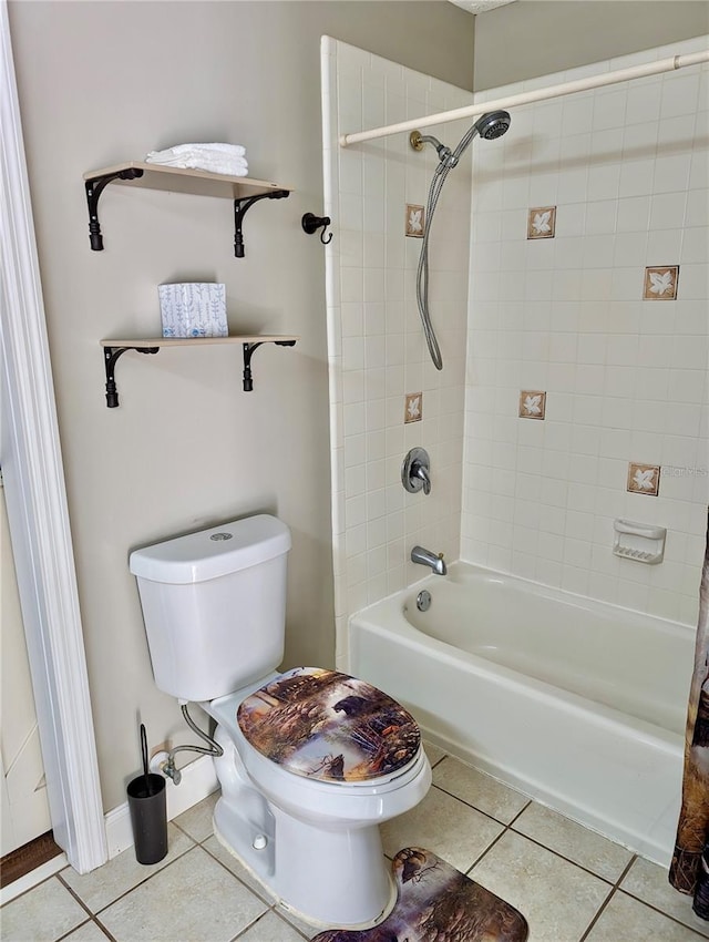 bathroom featuring toilet, tiled shower / bath combo, and tile patterned floors