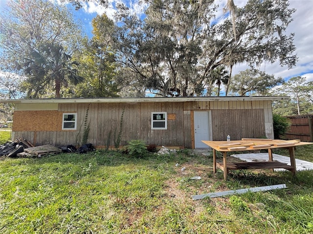 view of outbuilding featuring a lawn