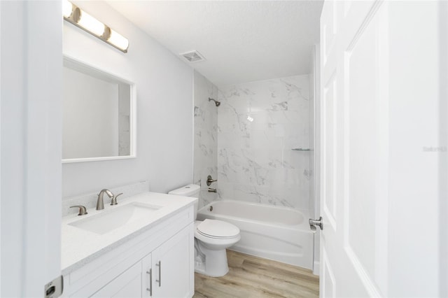 full bath with visible vents, toilet, vanity, wood finished floors, and  shower combination