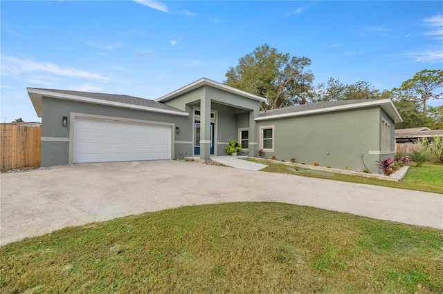 view of front facade with a garage and a front lawn