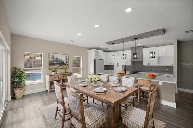 dining room featuring sink and light hardwood / wood-style flooring