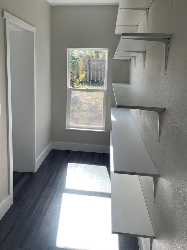 unfurnished dining area with dark hardwood / wood-style floors