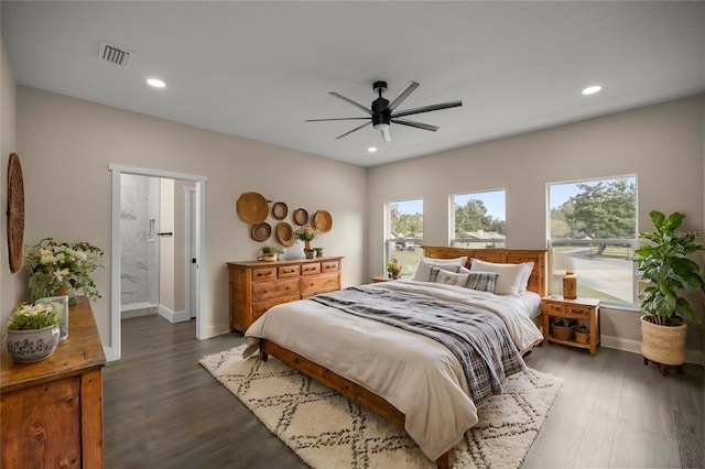 bedroom with dark hardwood / wood-style flooring, ceiling fan, and ensuite bath