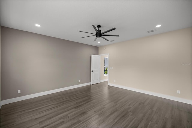 spare room featuring dark hardwood / wood-style floors and ceiling fan