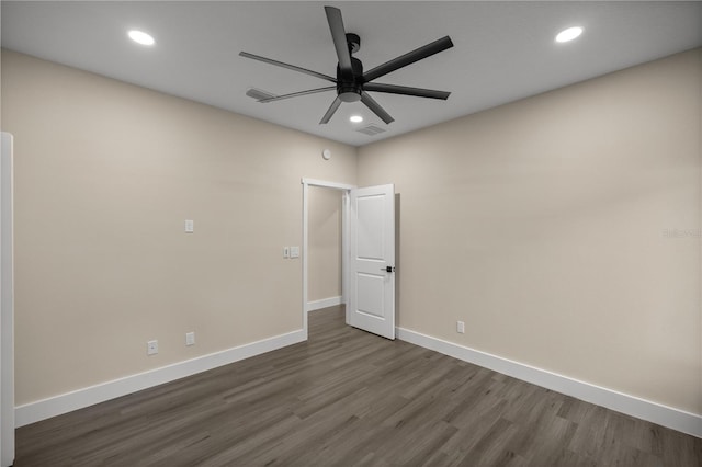 spare room featuring ceiling fan and dark hardwood / wood-style flooring