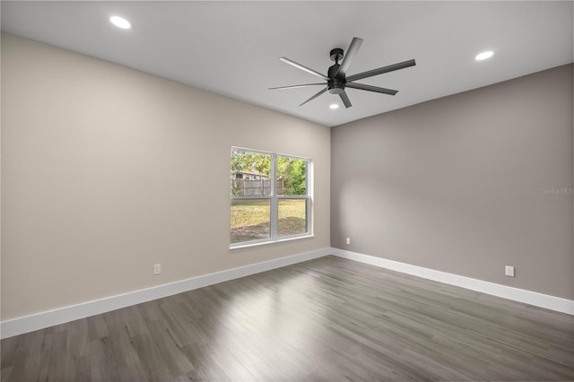 unfurnished room featuring ceiling fan and dark hardwood / wood-style flooring