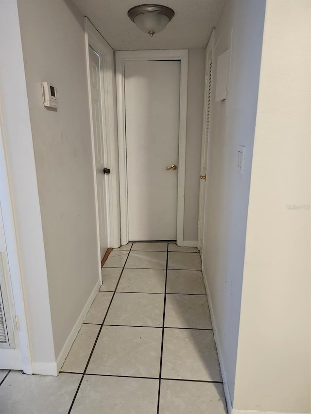 hallway with light tile patterned floors