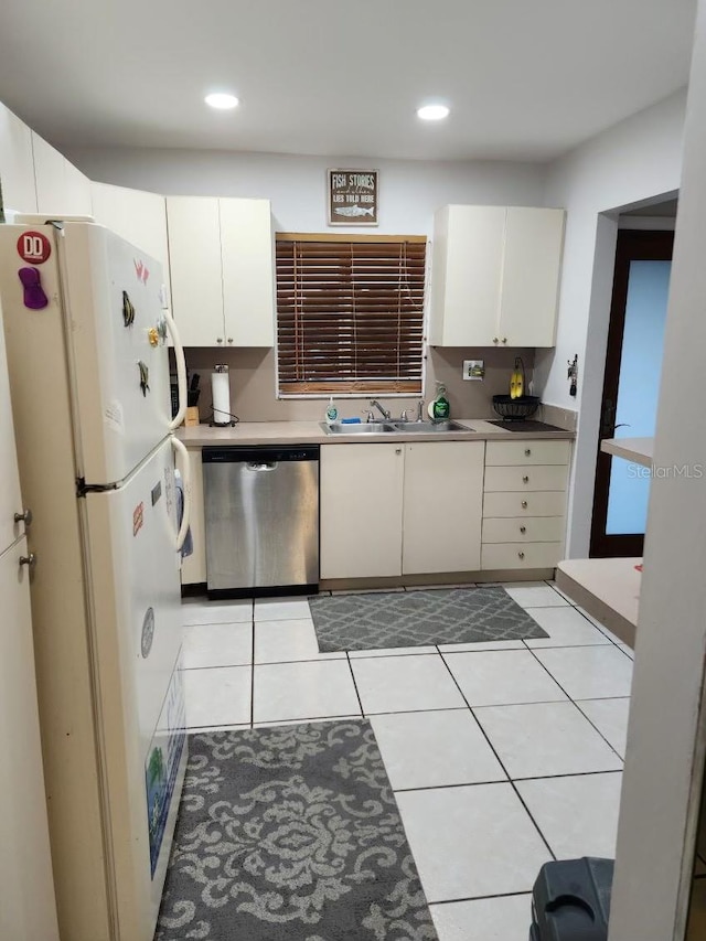 kitchen featuring white cabinets, dishwasher, white fridge, and sink