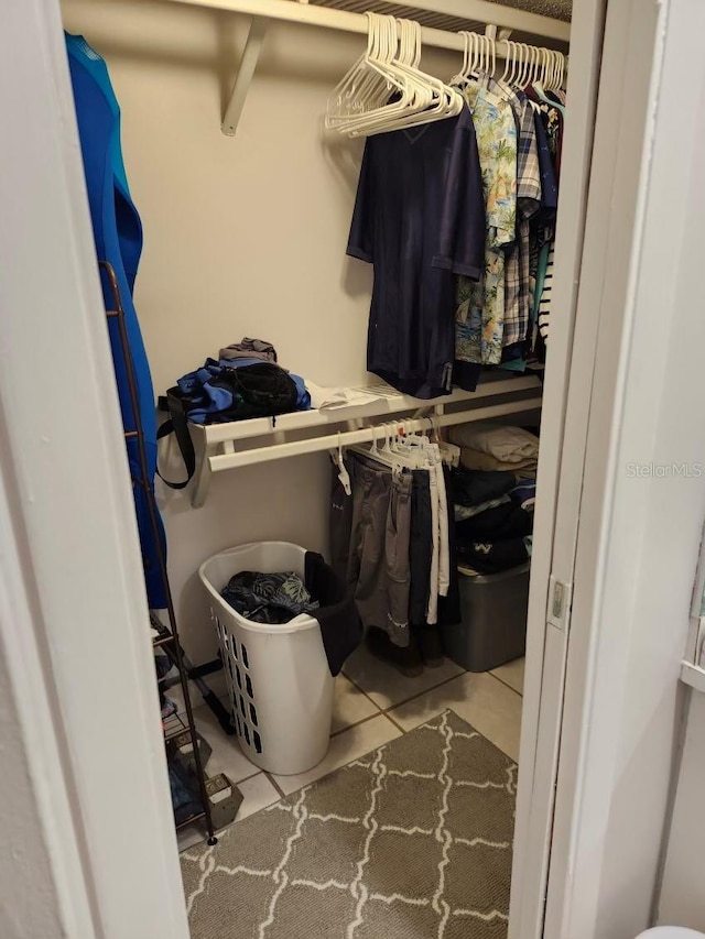 spacious closet with light tile patterned floors