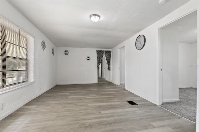 empty room with light hardwood / wood-style flooring