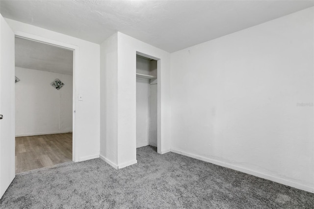 unfurnished bedroom with carpet floors and a closet