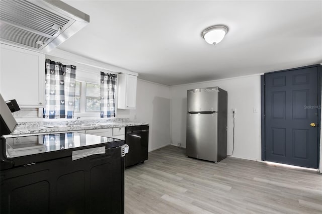 kitchen featuring light hardwood / wood-style flooring, light stone countertops, black dishwasher, white cabinetry, and stainless steel refrigerator