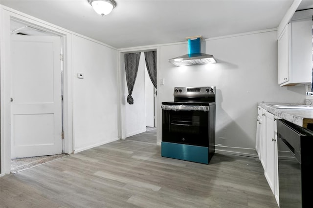 kitchen featuring white cabinetry, light wood-type flooring, wall chimney range hood, and appliances with stainless steel finishes