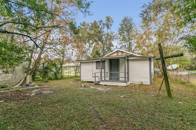 rear view of property with a lawn