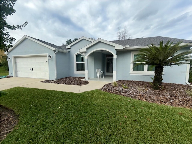 single story home featuring a garage and a front lawn