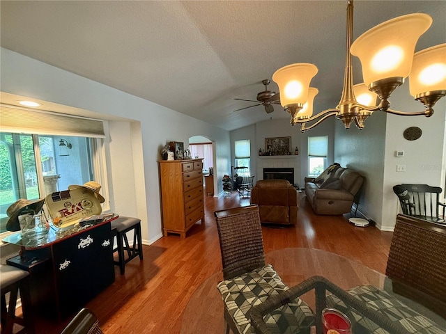 dining room with a healthy amount of sunlight, lofted ceiling, and dark wood-type flooring