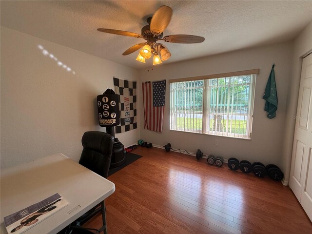 office with wood-type flooring, a textured ceiling, and ceiling fan