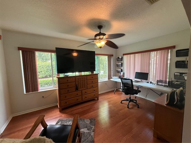 office featuring ceiling fan, wood-type flooring, and a textured ceiling